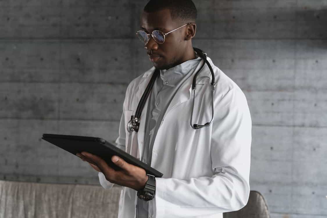 doctor reviewing data on tablet hospital